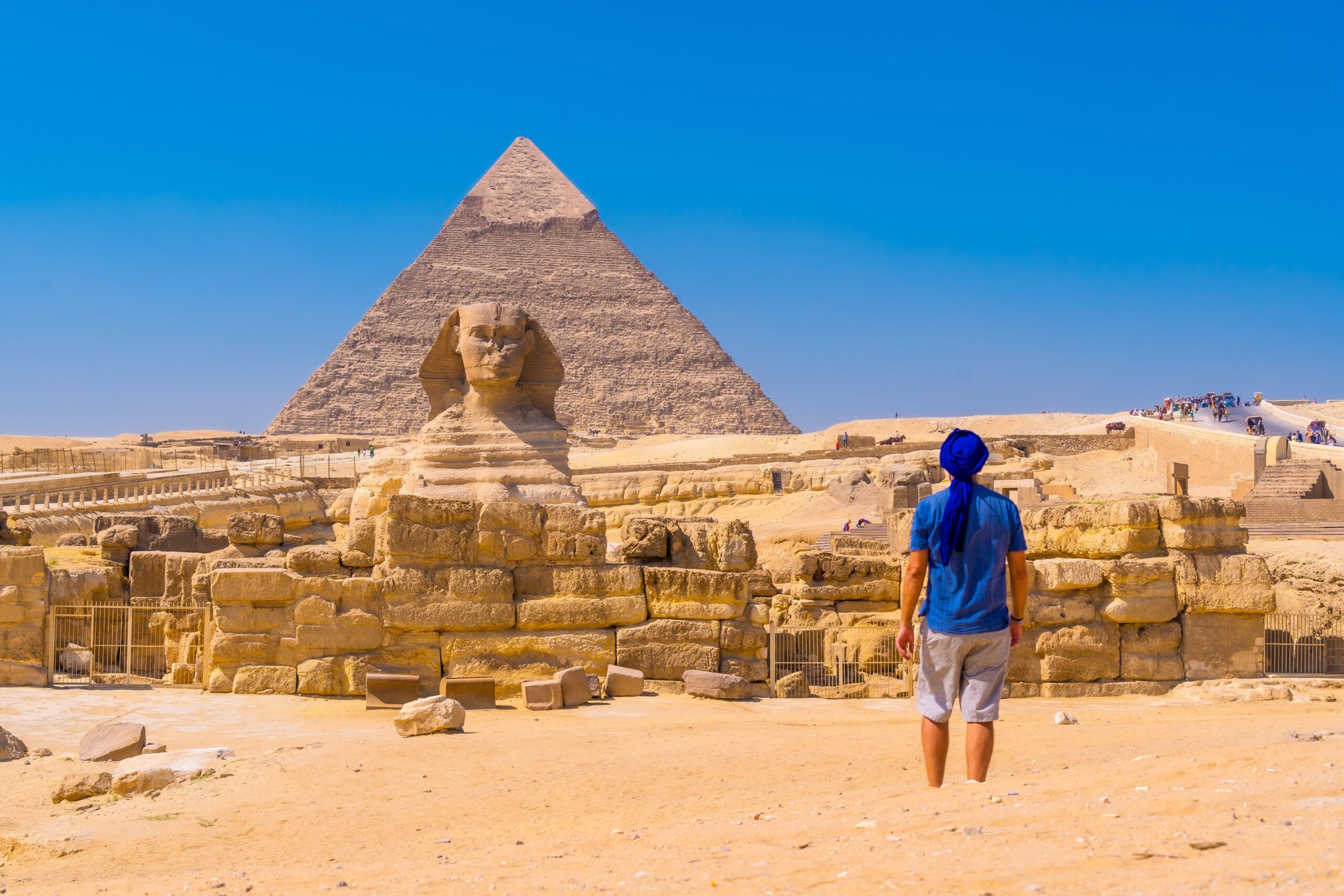 young-man-walking-towards-great-sphinx-giza-min